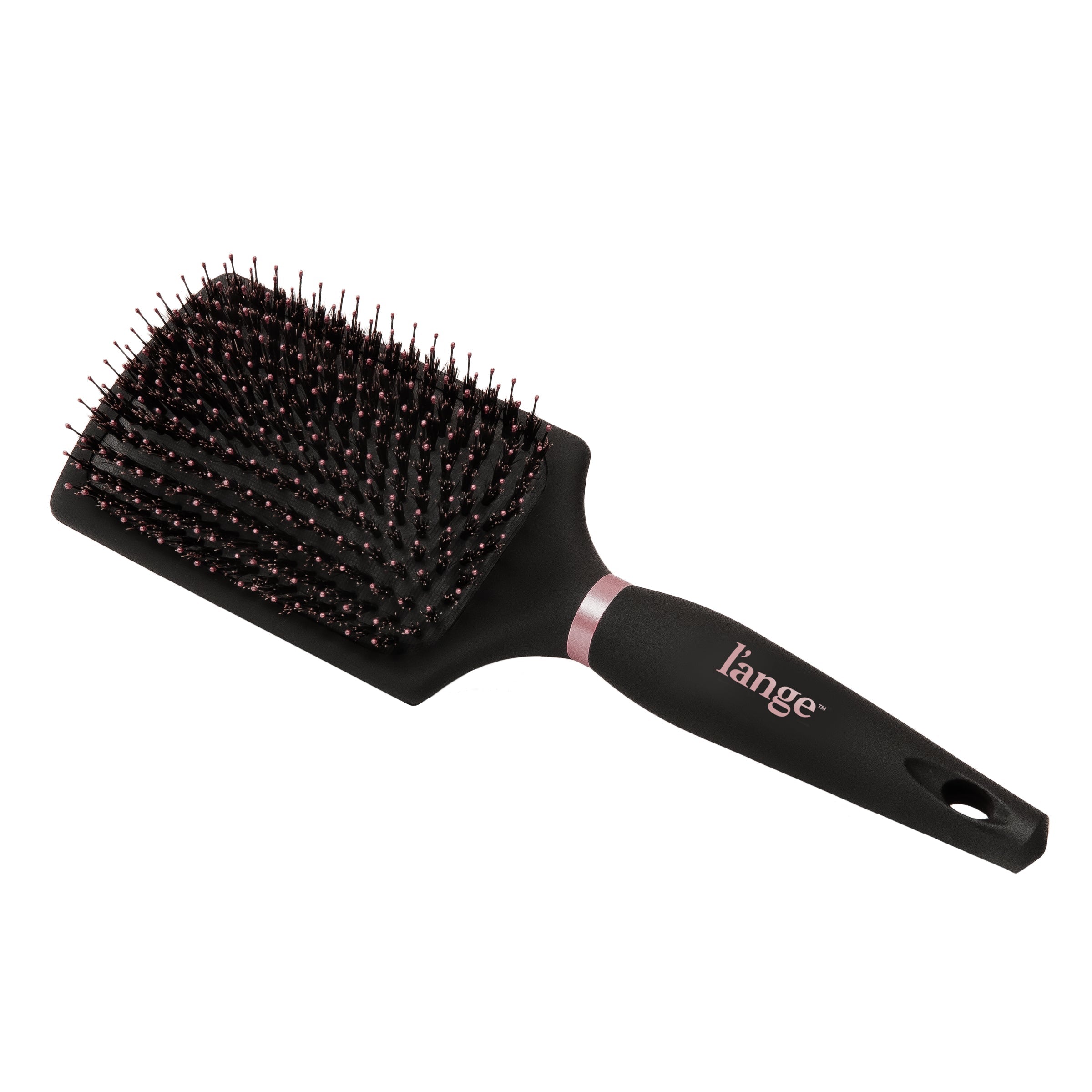 Resting diagonally, the black boar bristle brush displays the logo and hanging loop of the handle.
