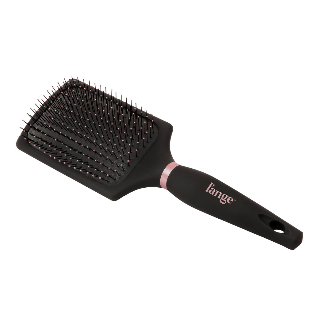 A diagonal view of the black Siena Paddle Brush shows the pink-tipped bristles, decorative pink ring, and logo.