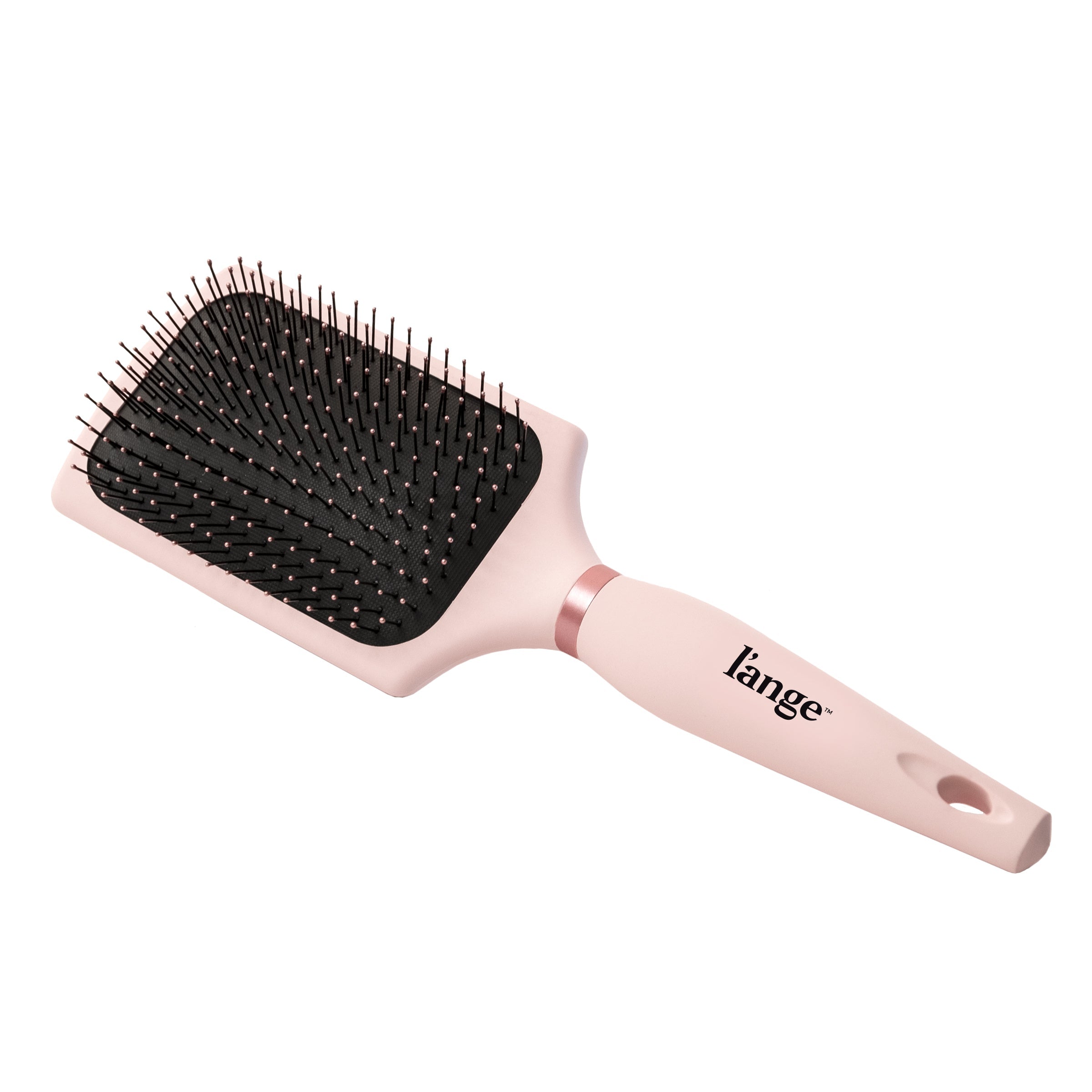 A pink paddle brush sits diagonally in a white background, displaying the logo & cushioned bristles.