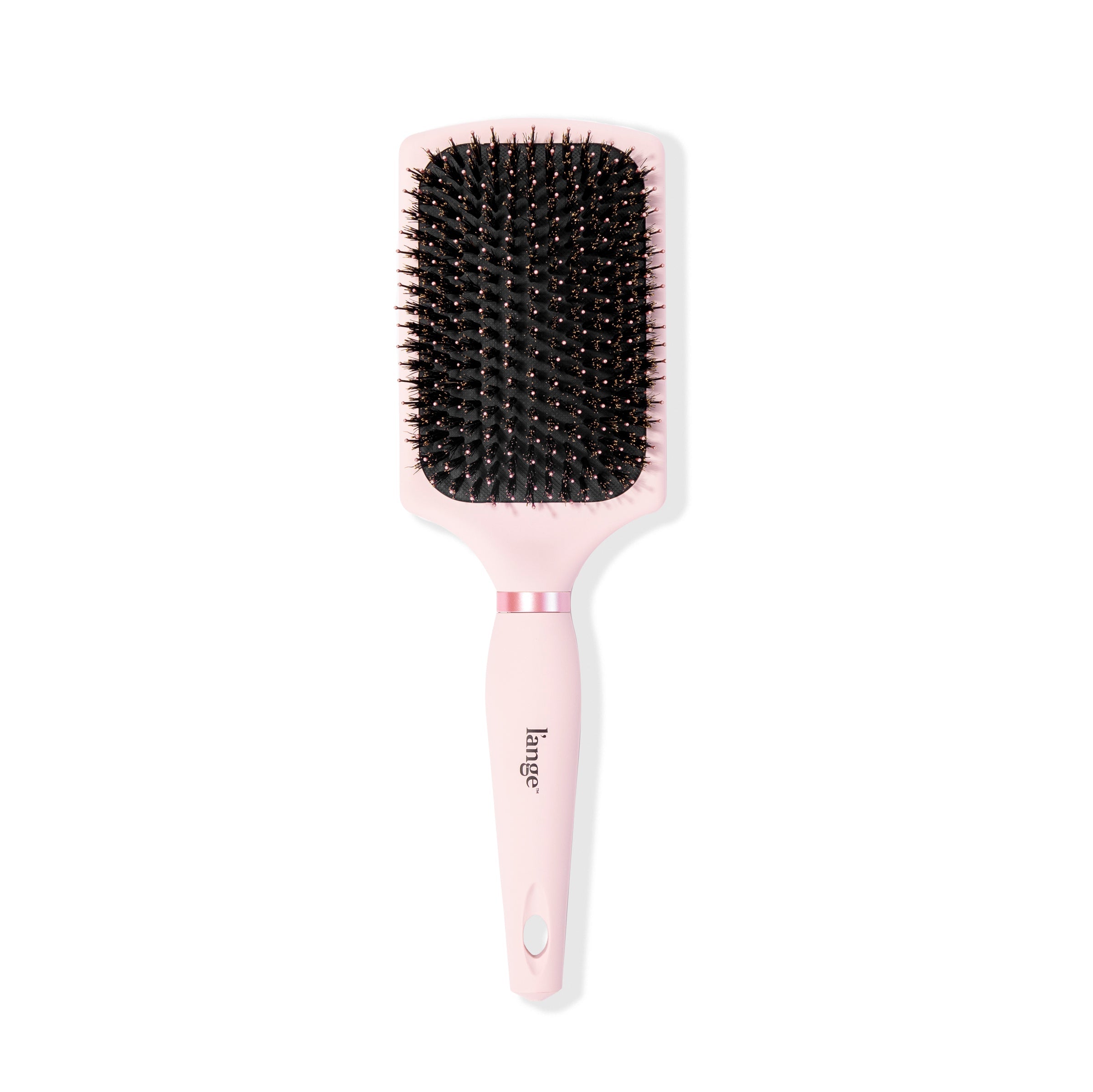 Standing vertically, the pink boar bristle brush displays its rectangular shape & soft-grip handle.