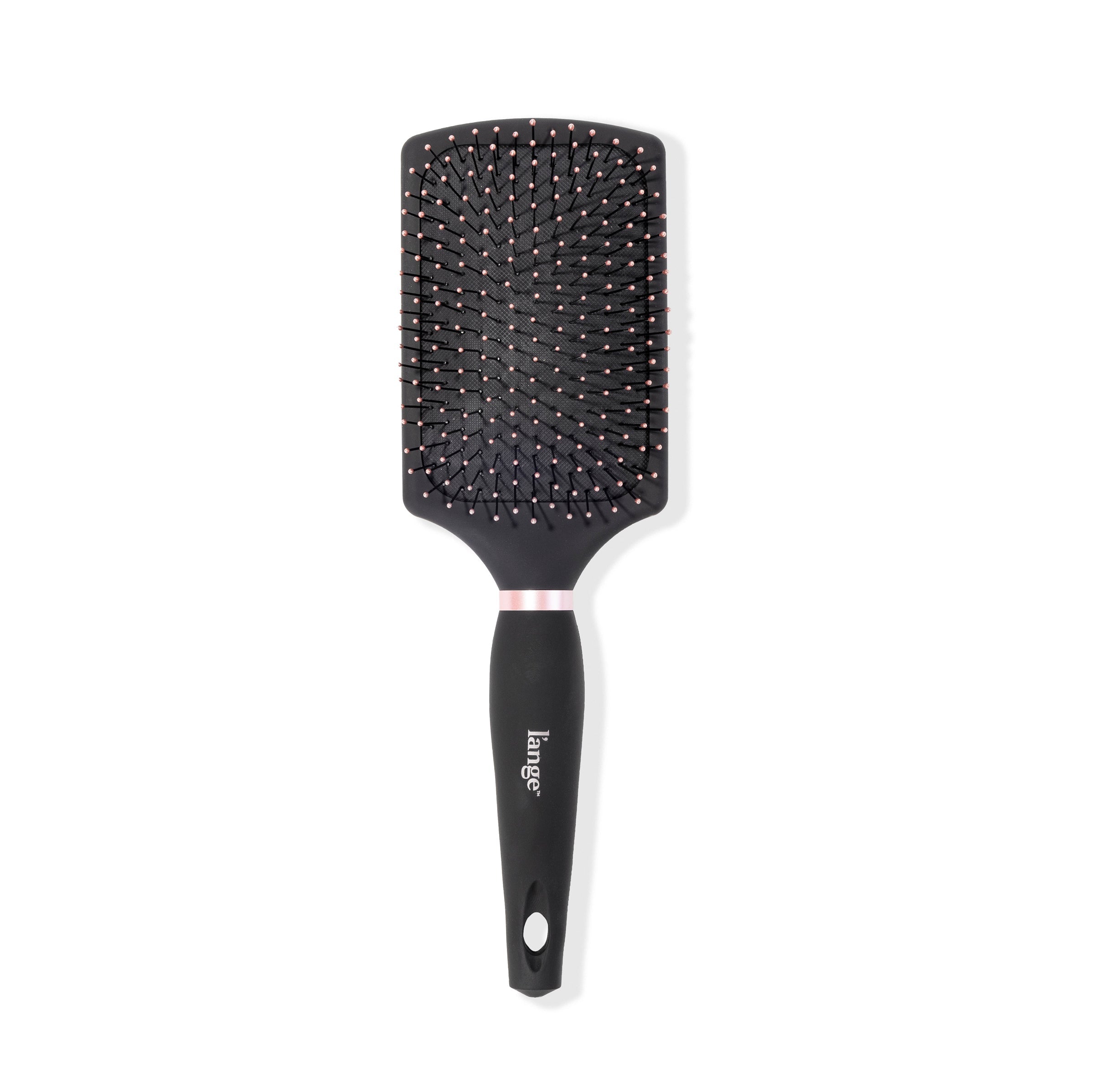 The black Siena Paddle Brush stands vertically so you can clearly see the rectangular shape.