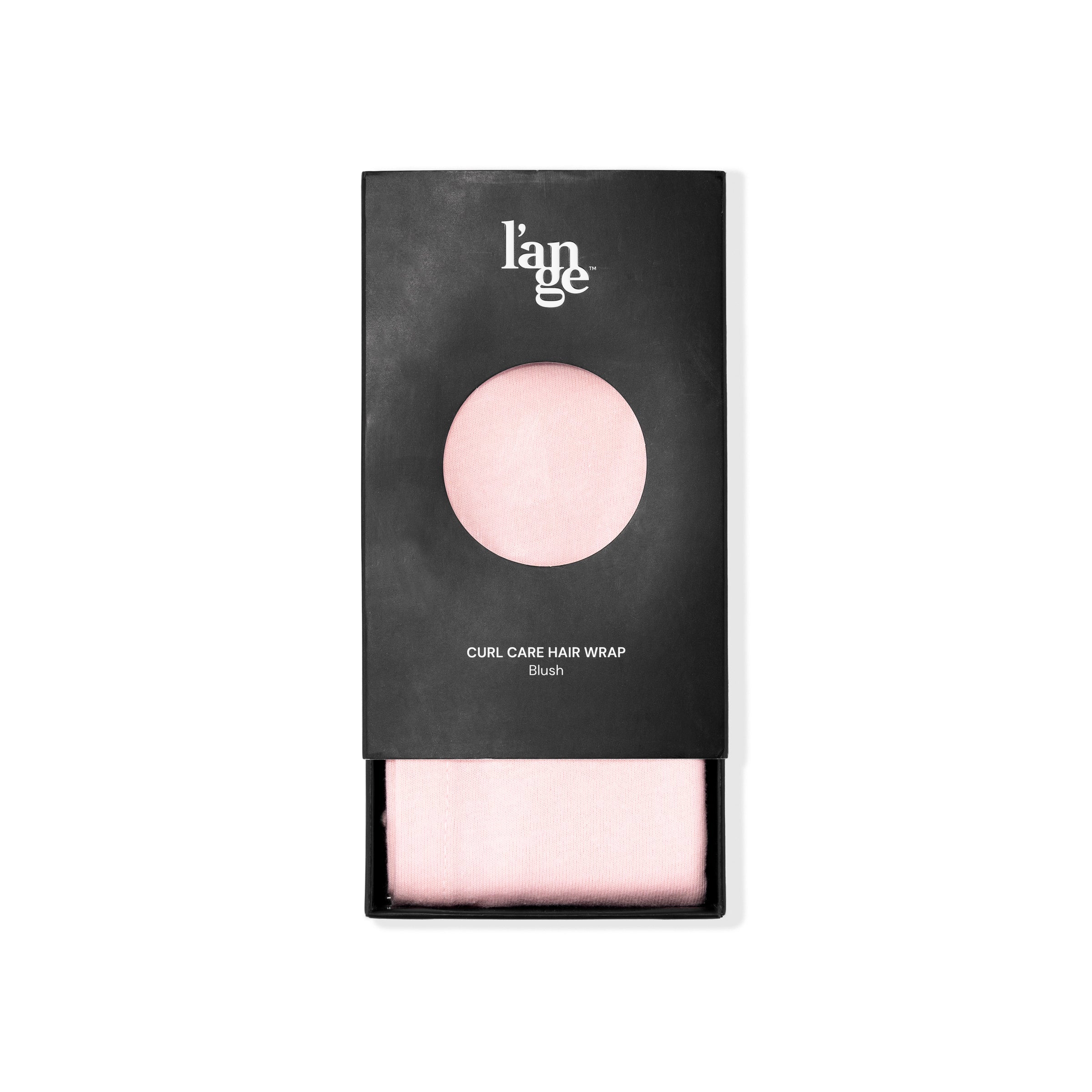 The packaging for the blush hair wrap towel is slightly open so you can see its pink color.