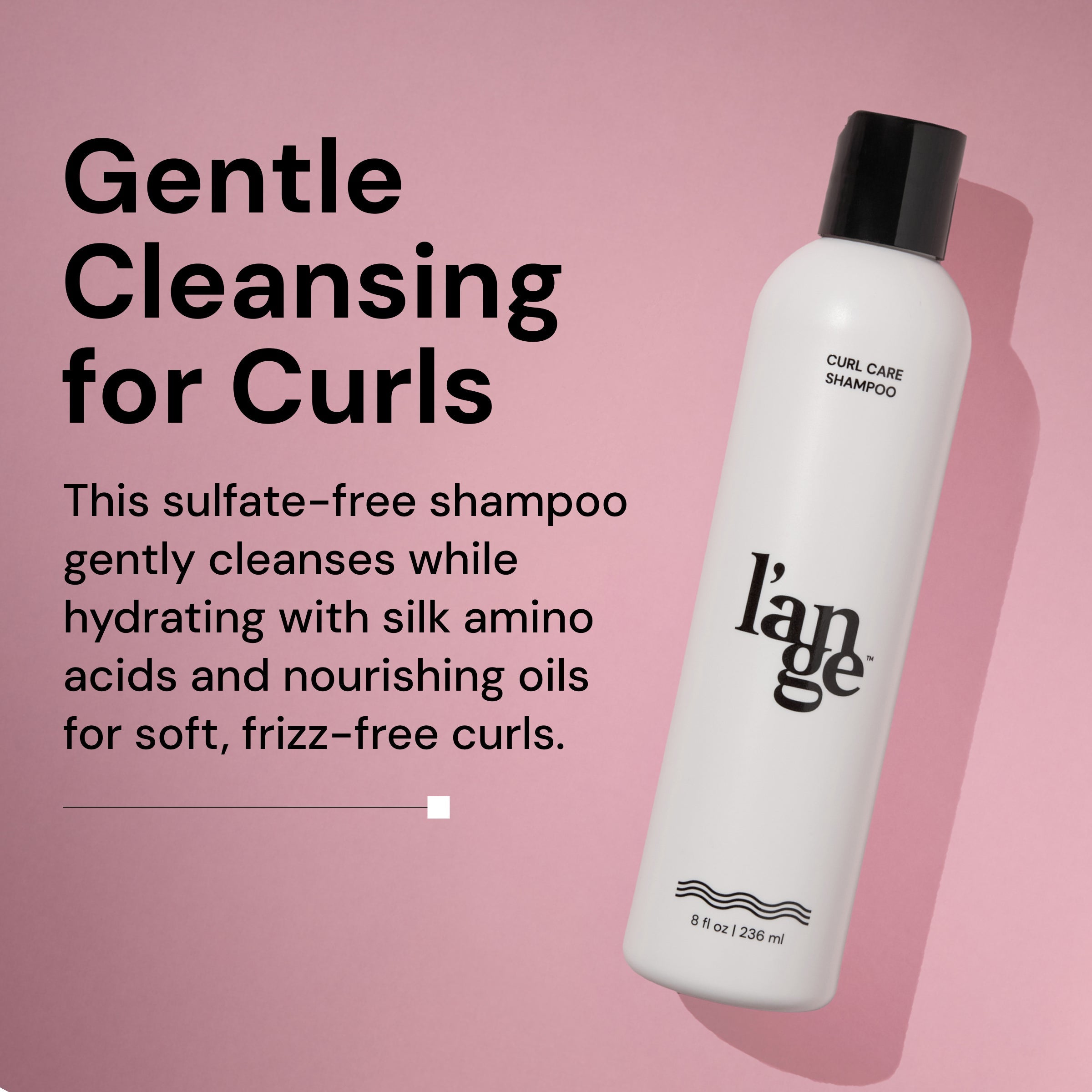 A bottle of L’ange Curl Care Shampoo is displayed against a pink background, angled with a shadow. On the left, bold text reads: 'Gentle Cleansing for Curls.' Below, supporting text says: 'This sulfate-free shampoo gently cleanses while hydrating with silk amino acids and nourishing oils for soft, frizz-free curls.' The white bottle features the l’ange logo and product information, indicating it contains 8 fl oz (236 ml)