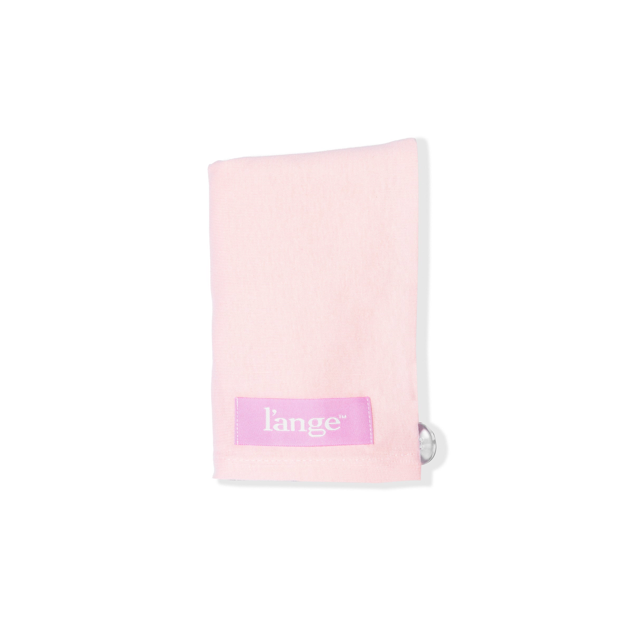 The blush-colored hair wrap towel is folded with the logo and suction cup showing.