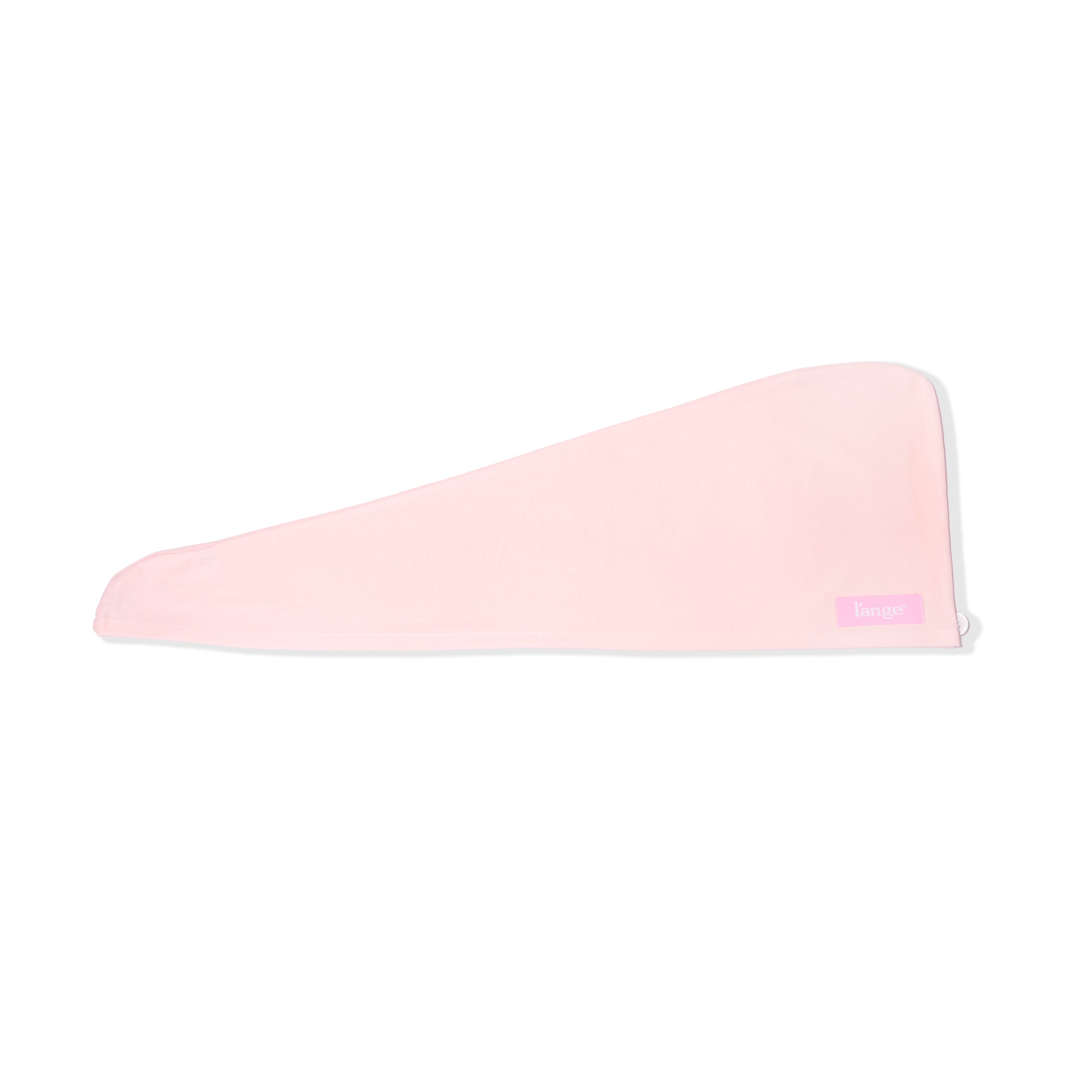 The pink hair wrap towel is unfolded so you can see its triangular shape. 