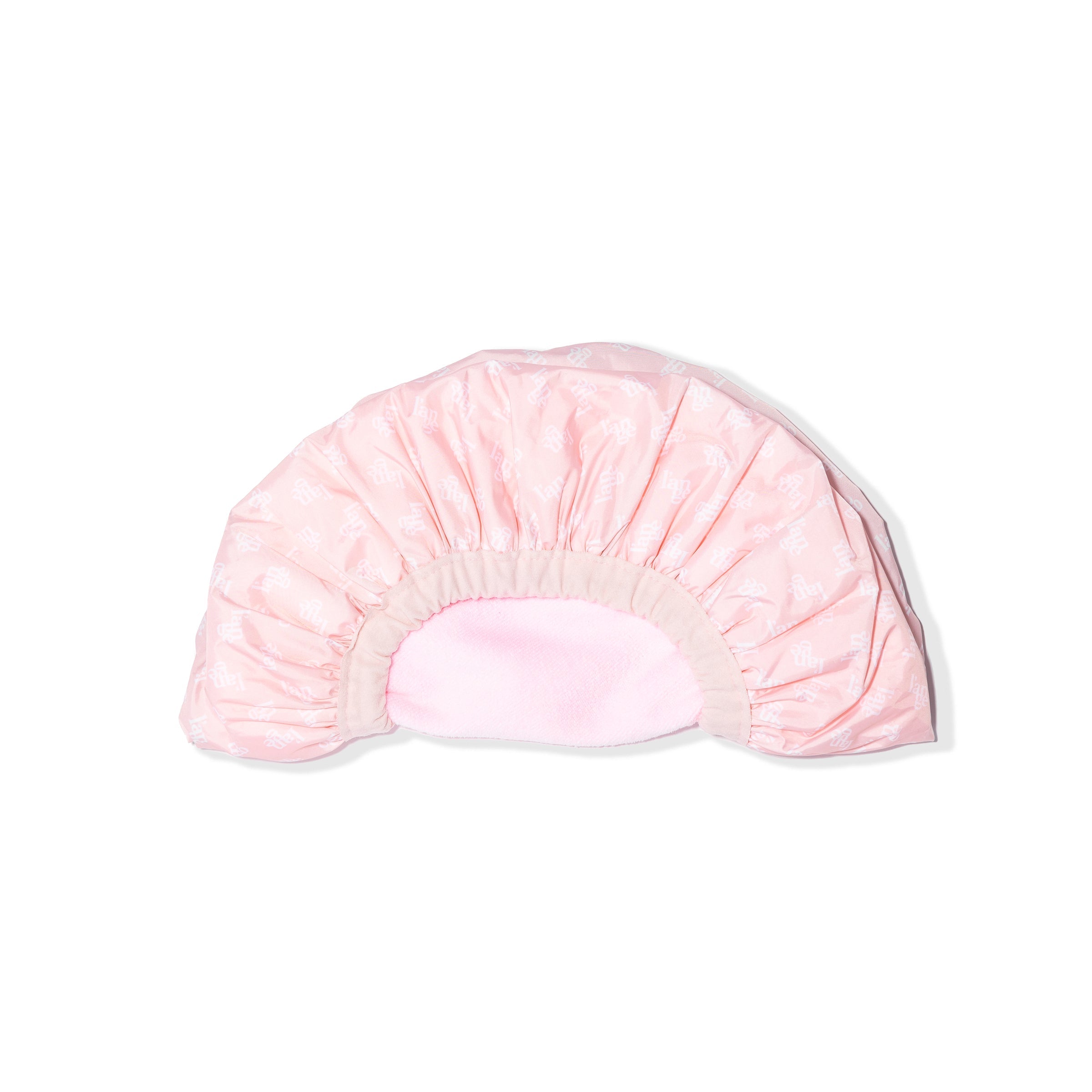 The reversible shower cap is folded in half so you can see the light elastic and both sides.