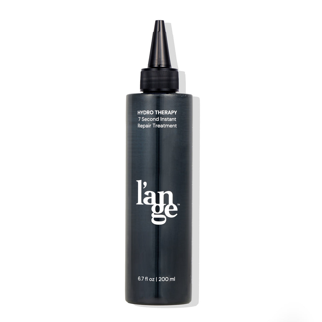 A sleek black bottle labeled "Hydro Therapy 7 Second Instant Repair Treatment" with a pointed applicator cap, containing 6.7 fl oz (200 ml) of product.