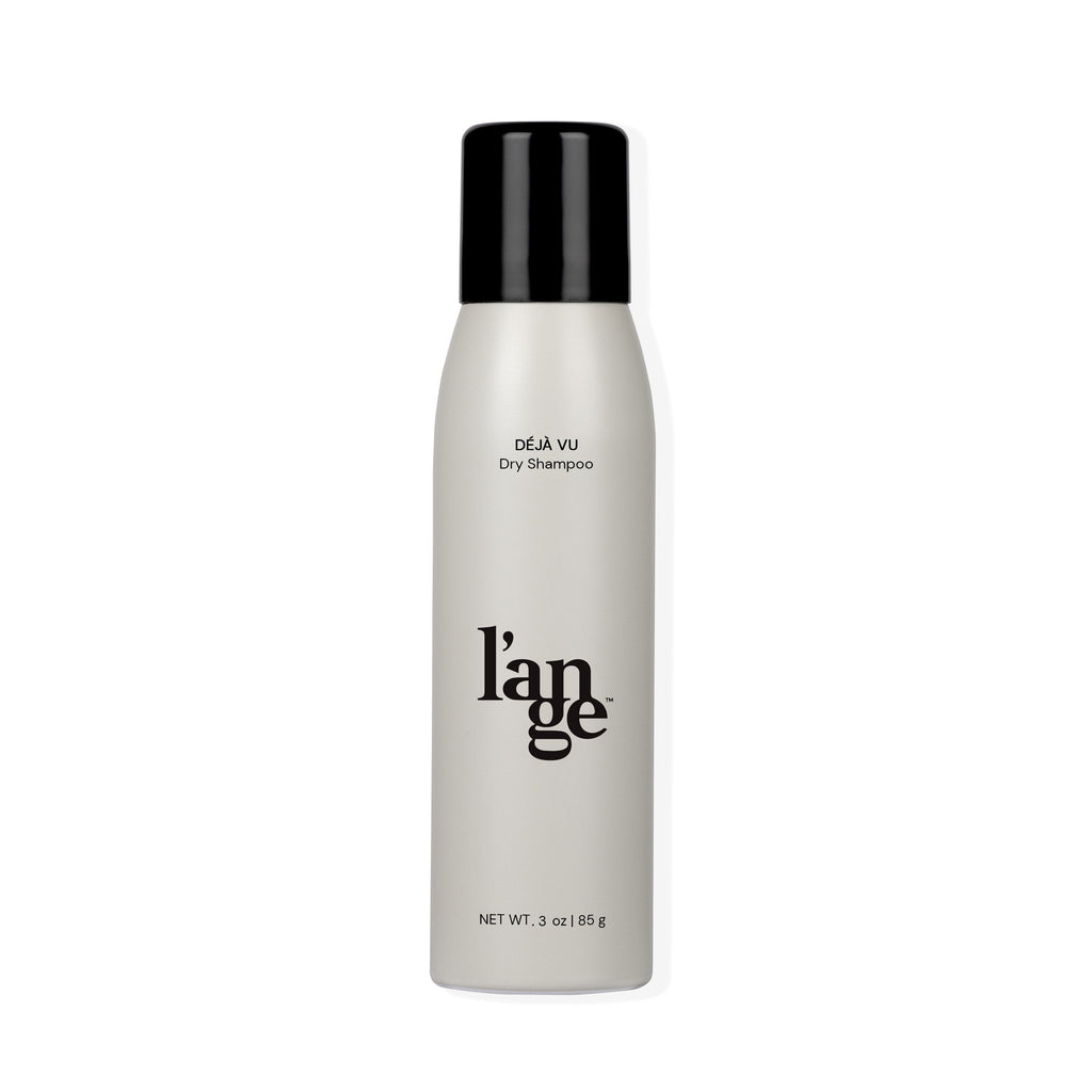 A sleek cylindrical bottle with a black cap, labeled "Déjà Vu Dry Shampoo" and featuring the brand name "l'ange" in bold lettering, containing 3 oz (85 g) of product.
