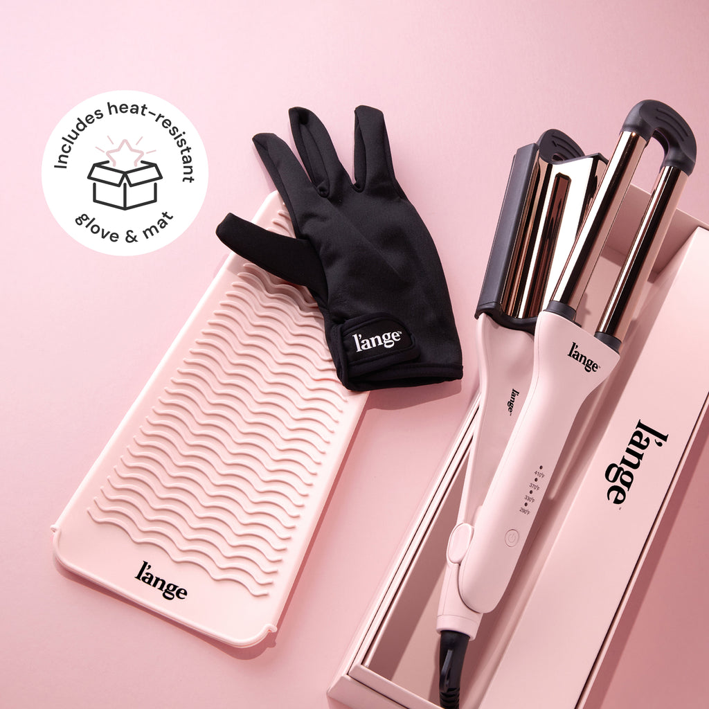 A hair styling set includes a dual-barrel curling iron, a wavy heat-resistant mat, and a black heat-resistant glove, all branded with "L'ange" and set against a pink background.