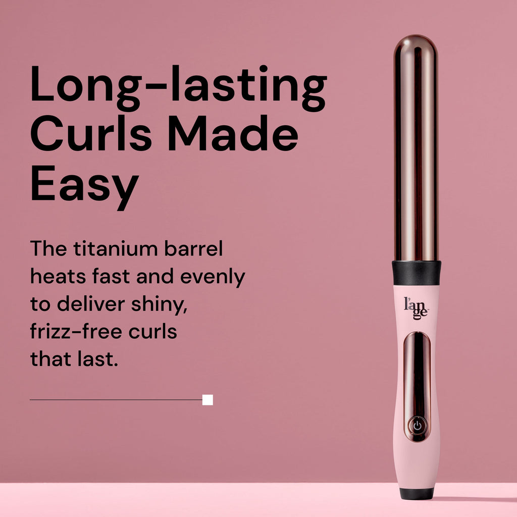 A L’ange curling wand with a rose gold barrel and pink handle is displayed upright on a pink background. Beside it, bold text reads: 'Long-lasting Curls Made Easy.' Supporting text says: 'The titanium barrel heats fast and evenly to deliver shiny, frizz-free curls that last.'