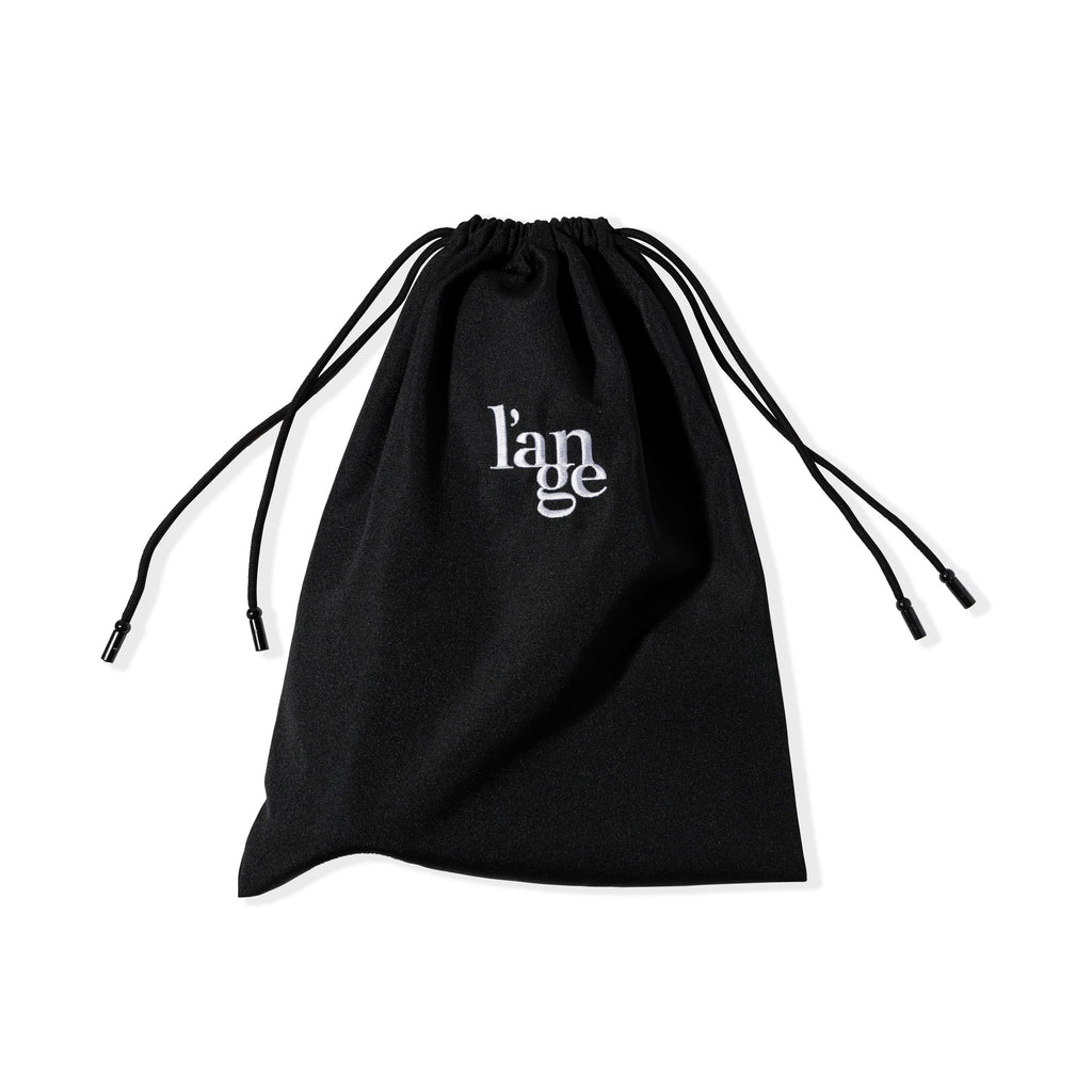 The drawstrings of the black hair tool bag are pulled tight to show the bag closed.