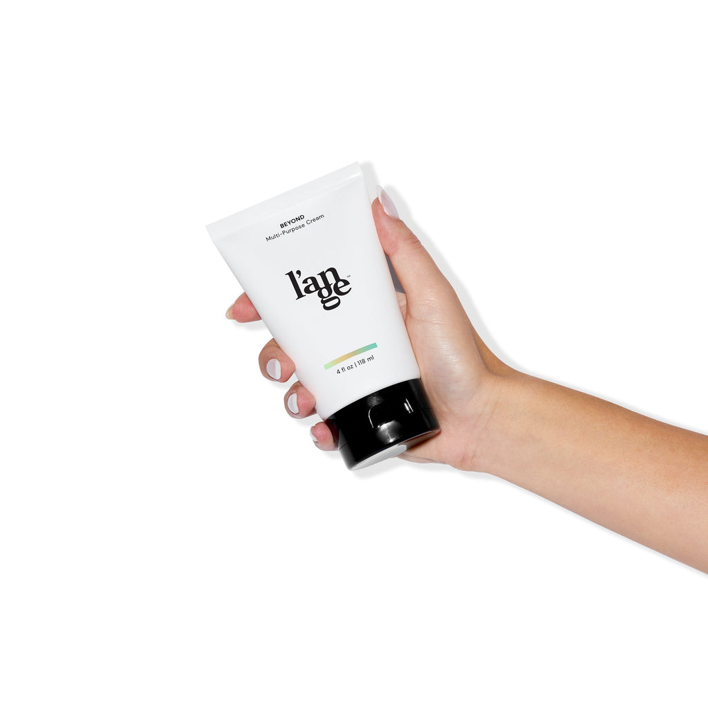 A model holding the The Beyond Multi-Purpose Cream on a white background.