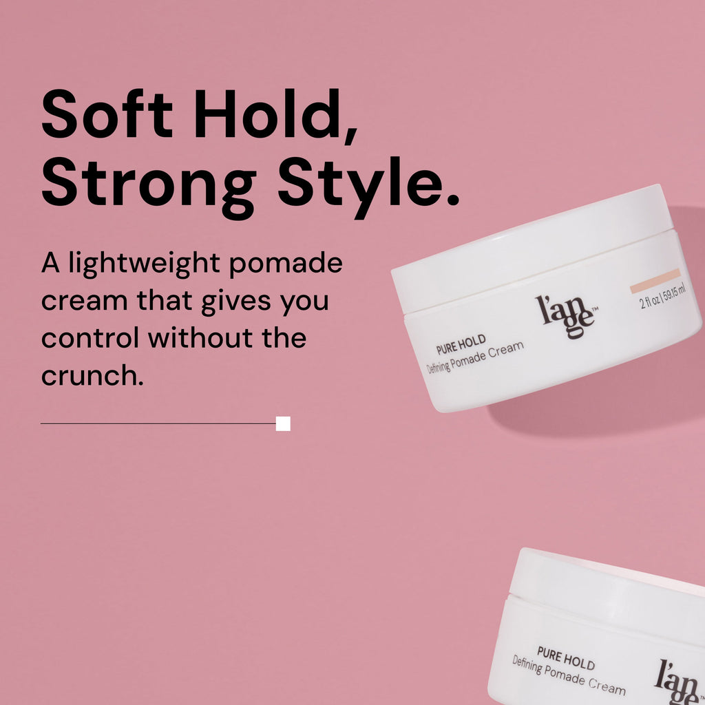 Defining Pomade Cream jars displayed on a pink background with text that reads "Soft Hold, Strong Style. A lightweight pomade cream that gives you control without the crunch"