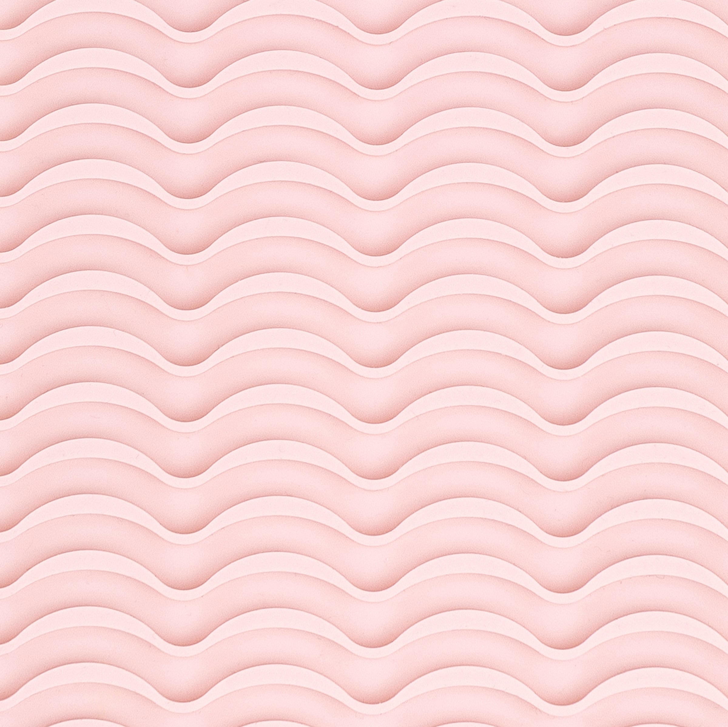 It shows a close-up of the silicone rippled surface of the styling tool heat-resistant mat.